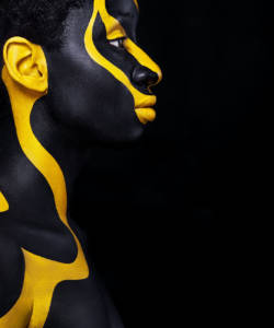 Art fashion makeup. An amazing woman with black makeup and leaking gold paint