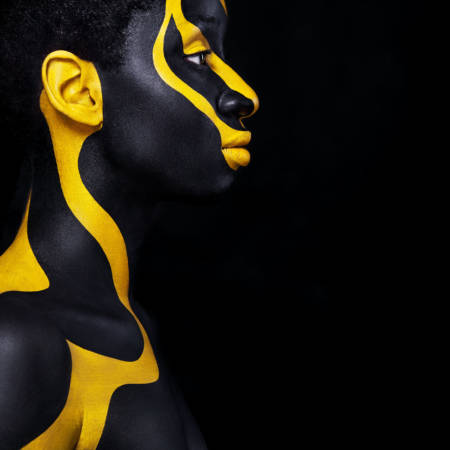 Art fashion makeup. An amazing woman with black makeup and leaking gold paint