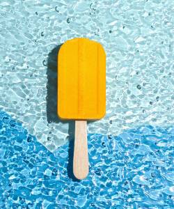 A bath bomb in the shape of an ice cream yellow. Summer concept