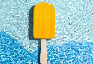 A bath bomb in the shape of an ice cream yellow. Summer concept