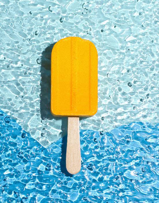 A bath bomb in the shape of an ice cream yellow. Summer concept