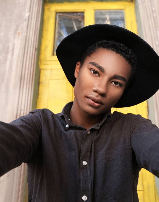 Stylish young African-American man taking selfie outdoors