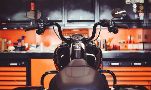 motorcycles on the floor with workshop tools, a modern garage, storage and repair. This bike will be perfect. repairing a motorcycle in a repair shop.