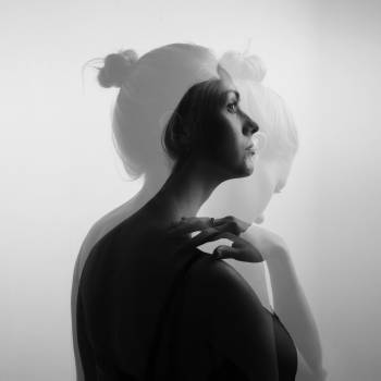 Creative double exposure portrait of a beautiful woman, monochro